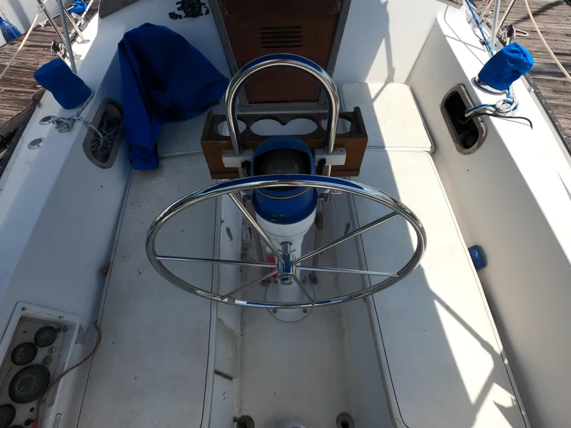 Slide: The Image of Cockpit of a 1985 Catalina 30 sailboat with steering wheel and controls. - 7