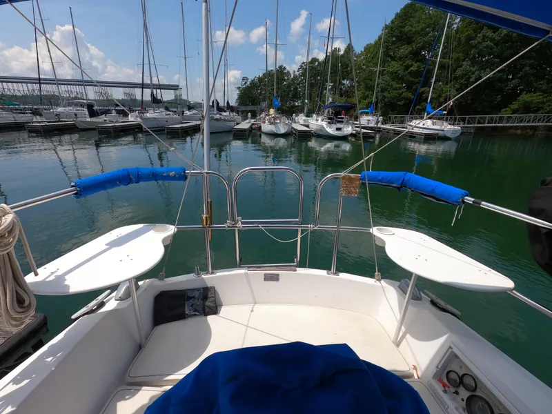 Slide: The Image of Cockpit view of a 1985 Catalina 30 sailboat docked in a marina. - 8