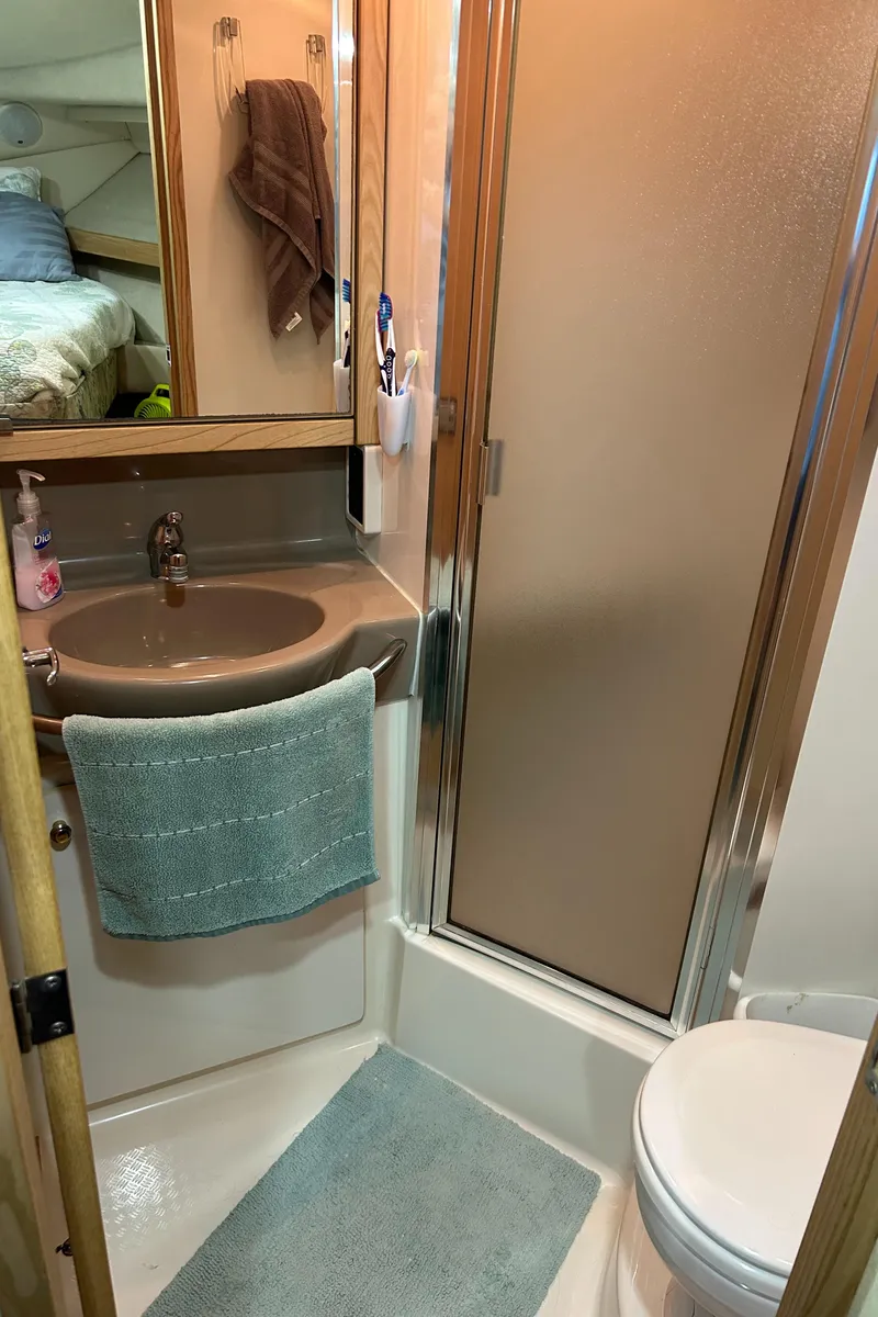 Slide: The Image of Bathroom interior of 1997 Bayliner 3788 Command Bridge Motoryacht with sink, shower, and toilet. - 14