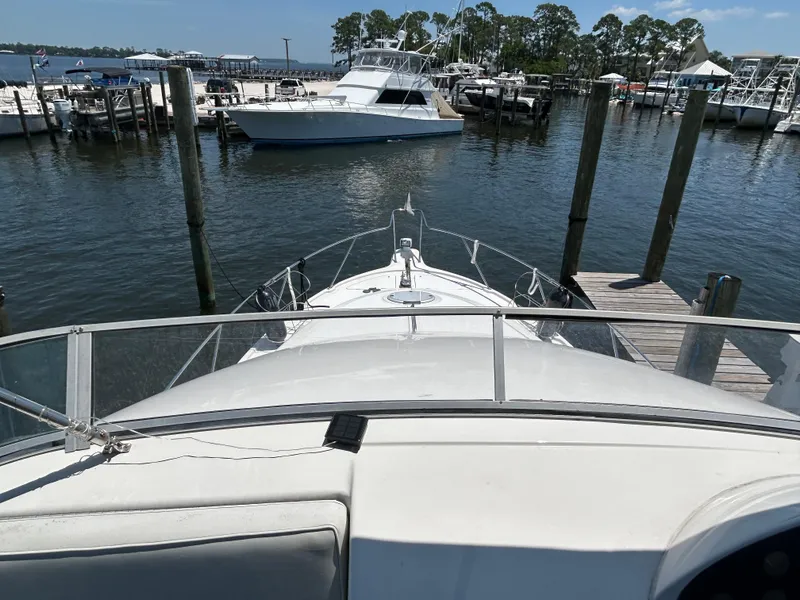 Slide: The Image of 1997 Bayliner 3788 Command Bridge Motoryacht docked at a marina, view from the bridge. - 4
