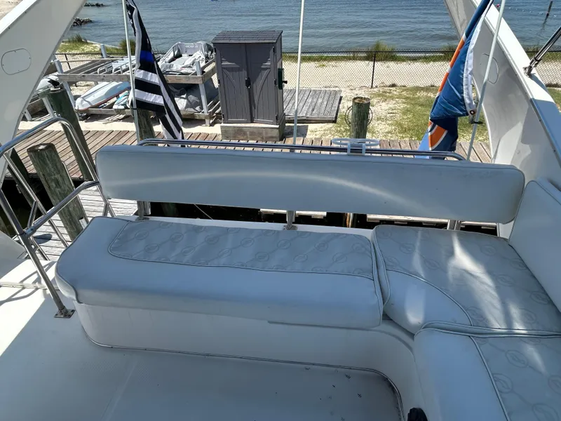 Slide: The Image of 1997 Bayliner 3788 Command Bridge Motoryacht seating area with waterfront view. - 7