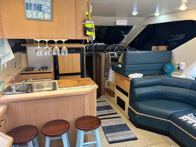 Slide: The Image of Interior of 1997 Bayliner 3788 Command Bridge Motoryacht with kitchen and seating area. - 8