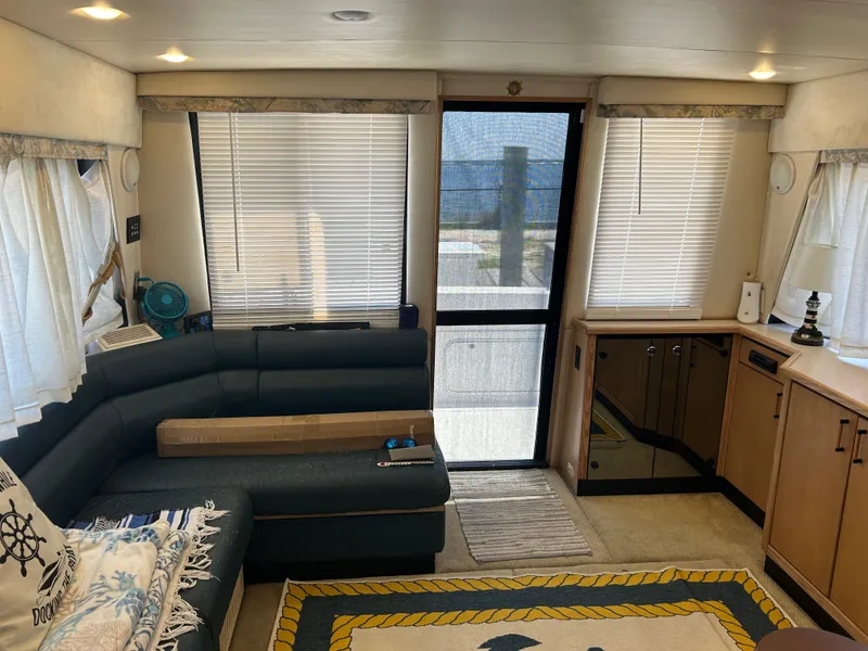 Slide: The Image of Interior of 1997 Bayliner 3788 Command Bridge Motoryacht with cozy seating and nautical decor. - 9
