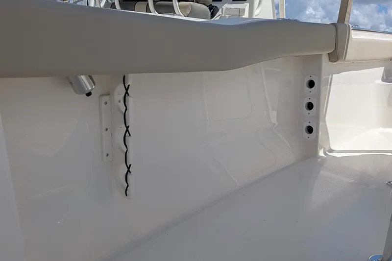 Slide: The Image of Interior view of 2026 Key West 203 FS boat, featuring sleek white design and rod holders. - 11