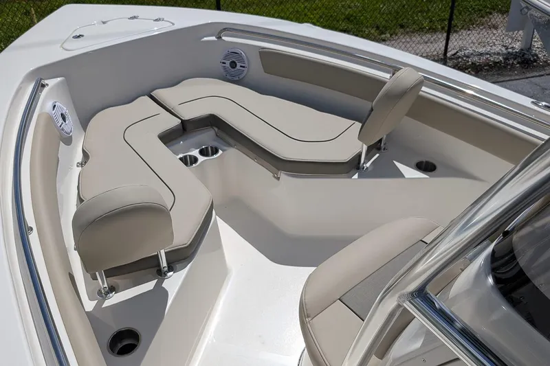 Slide: The Image of 2026 Key West 203 FS boat interior with beige seating and cup holders. - 16