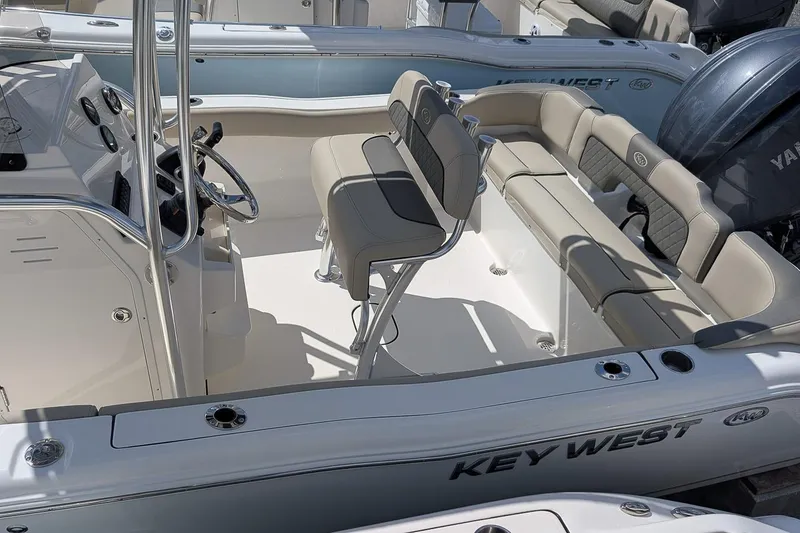 Slide: The Image of 2026 Key West 203 FS boat interior with seating and steering console. - 6