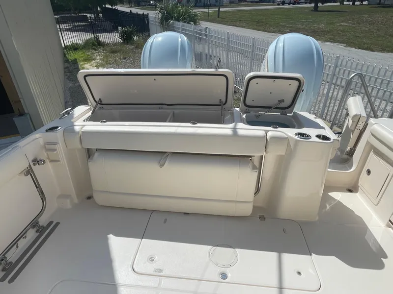 Slide: The Image of 2023 Grady-White Freedom 335 boat on trailer under a cloudy sky. - 1