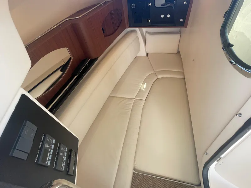 Slide: The Image of Garmin display on 2023 Grady-White Freedom 335 showing FM radio at 102.30 MHz. - 15