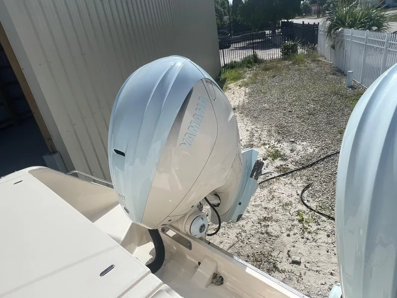 Slide: The Image of 2023 Grady-White Freedom 335 boat interior with steering wheel and beige seating. - 5