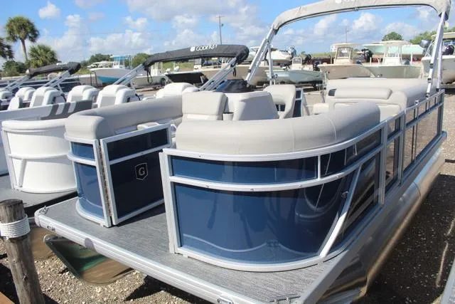 Slide: The Image of 2025 Godfrey Pontoons Xperience 1680 CX, blue and gray pontoon boat, docked under sunny skies. - 3