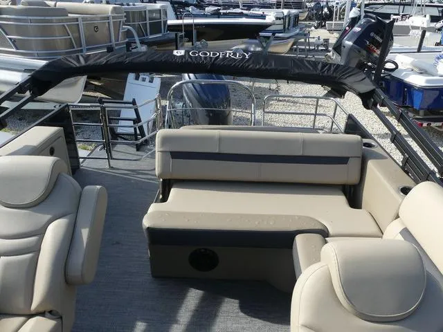 Slide: The Image of 2025 Godfrey Pontoons Sweetwater 2486 C with beige seating and canopy. - 12