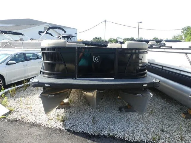 Slide: The Image of 2025 Godfrey Pontoons Sweetwater 2486 C pontoon boat, black exterior, parked outdoors. - 3