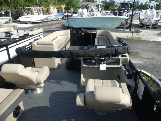 Slide: The Image of 2025 Godfrey Pontoons Sweetwater 2486 C helm with beige seating and steering console. - 6