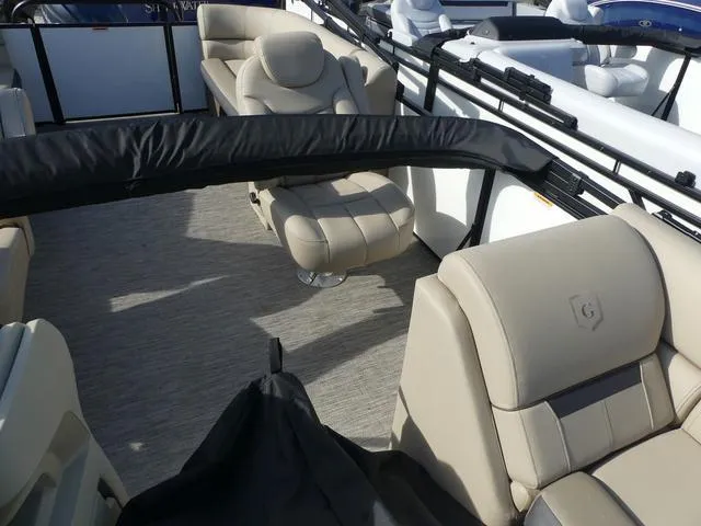 Slide: The Image of 2025 Godfrey Pontoons Sweetwater 2286 SB interior with beige seating and spacious layout. - 11