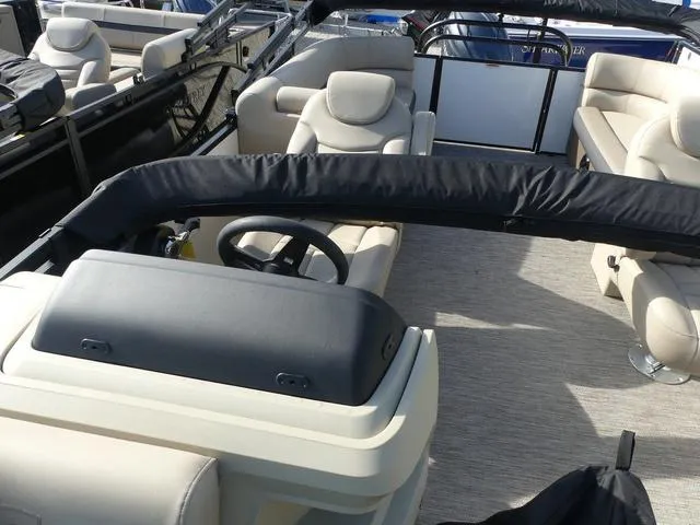 Slide: The Image of 2025 Godfrey Pontoons Sweetwater 2286 SB interior with plush seating and steering console. - 12