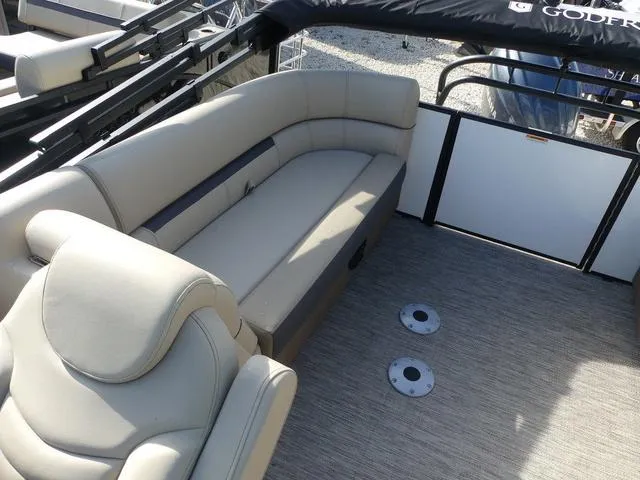 Slide: The Image of 2025 Godfrey Pontoons Sweetwater 2286 SB interior with beige seating and spacious deck. - 14
