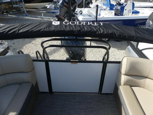 Slide: The Image of 2025 Godfrey Pontoons Sweetwater 2286 SB interior with seating and motor cover. - 15