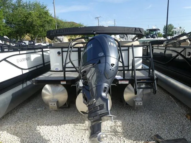 Slide: The Image of 2025 Godfrey Pontoons Sweetwater 2286 SB with Yamaha 150 engine, parked on gravel. - 3