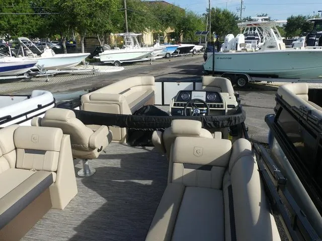 Slide: The Image of 2025 Godfrey Pontoons Sweetwater 2286 SB interior with beige seating at marina. - 5