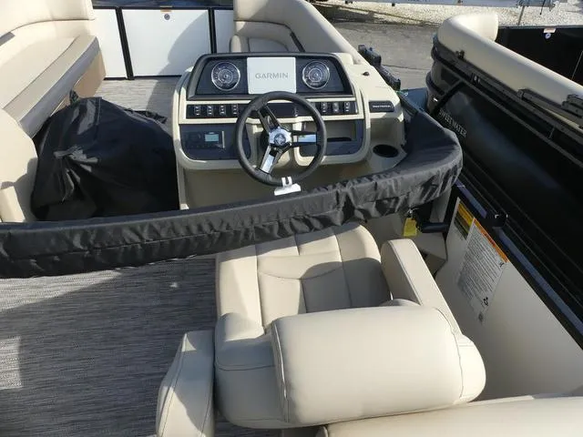 Slide: The Image of 2025 Godfrey Pontoons Sweetwater 2286 SB interior with Garmin dashboard and beige seating. - 6