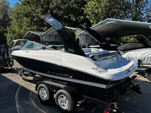 Slide: The Image of 2025 Regal 2000 ES boat on trailer, parked outdoors under a canopy. - 10