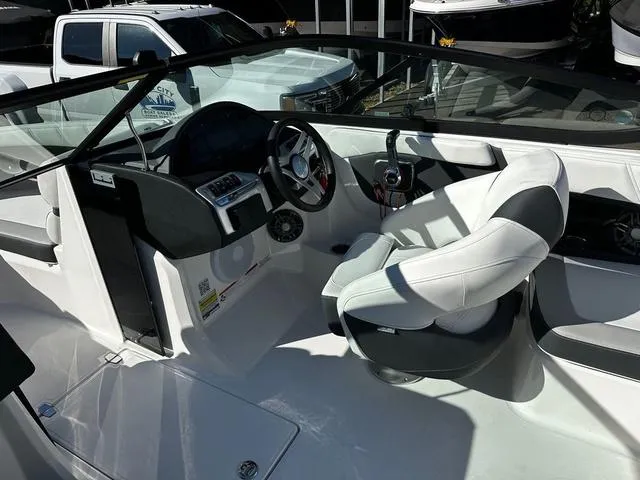 Slide: The Image of 2025 Regal 2000 ES boat interior with white seating and modern dashboard. - 8