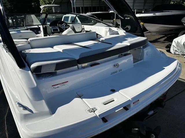Slide: The Image of 2025 Regal 2000 ES boat, sleek white design, spacious seating, modern interior. - 9