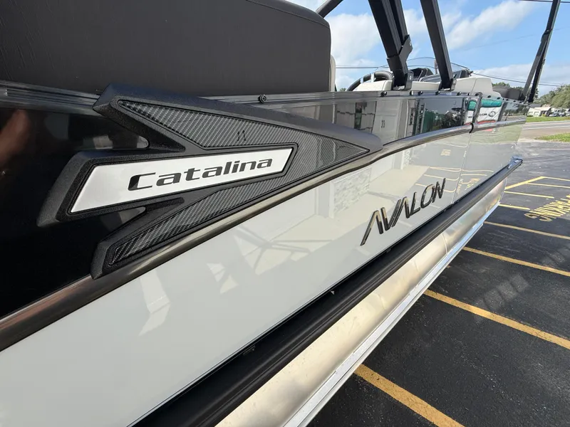 Slide: The Image of 2025 Avalon 2385 Catalina Quad Lounger, Tri Toon High Performance boat side view. - 13