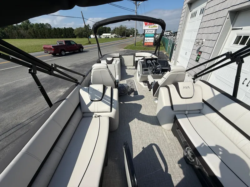 Slide: The Image of 2025 Avalon 2385 Catalina Quad Lounger, Tri Toon High Performance boat interior, parked on roadside. - 17
