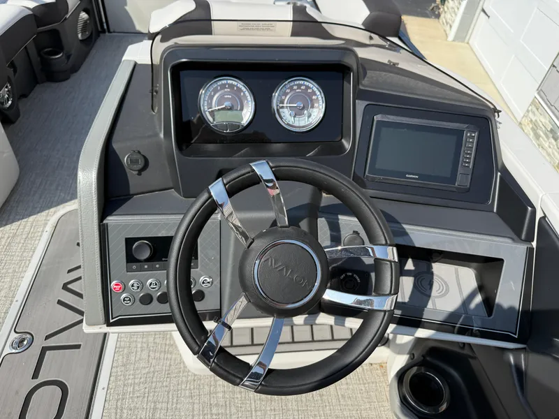 Slide: The Image of Steering console of 2025 Avalon 2385 Catalina Quad Lounger, featuring modern controls and gauges. - 23