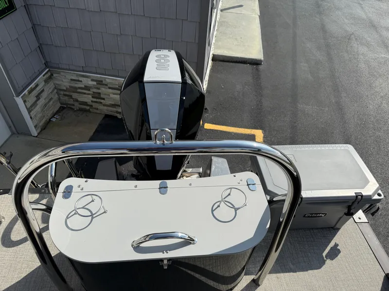Slide: The Image of 2025 Avalon 2385 Catalina Quad Lounger with outboard motor and rear deck view. - 28