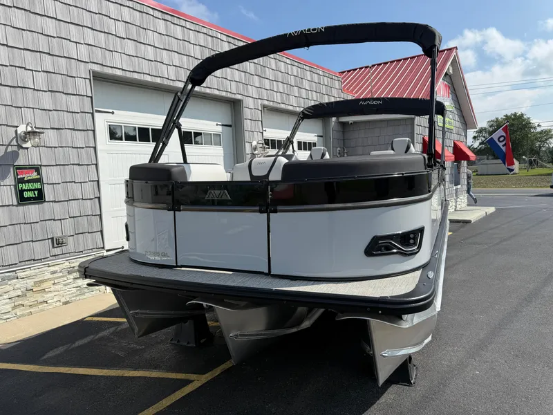 Slide: The Image of 2025 Avalon 2385 Catalina Quad Lounger Tri Toon boat parked outside a building. - 4