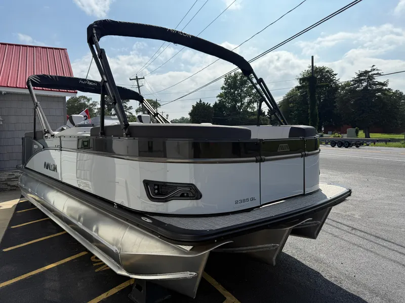 Slide: The Image of 2025 Avalon 2385 Catalina Quad Lounger Tri Toon boat parked outdoors. - 6