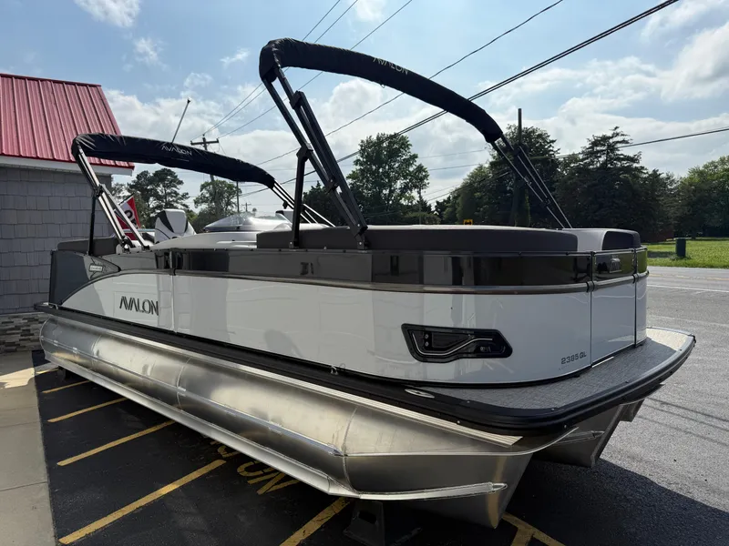 Slide: The Image of 2025 Avalon 2385 Catalina Quad Lounger Tri Toon boat, parked outdoors on a sunny day. - 7