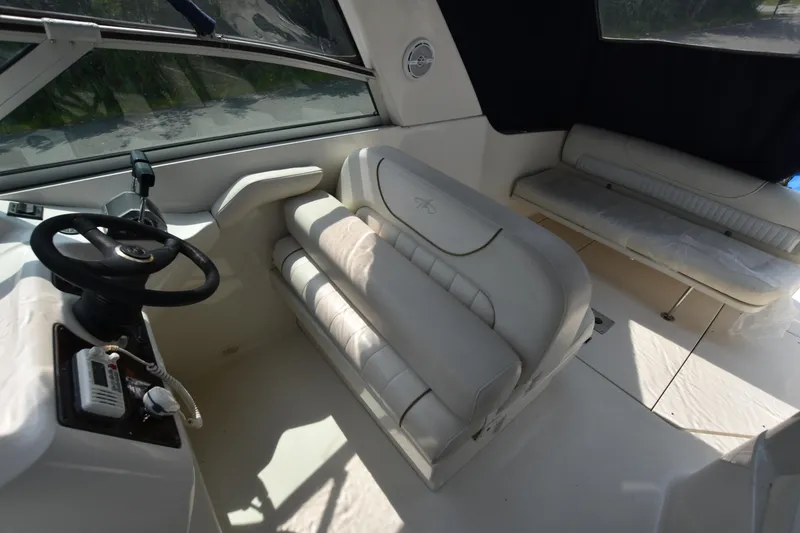 Slide: The Image of Interior of 2000 Monterey 302 Cruiser with white seating and steering wheel. - 10