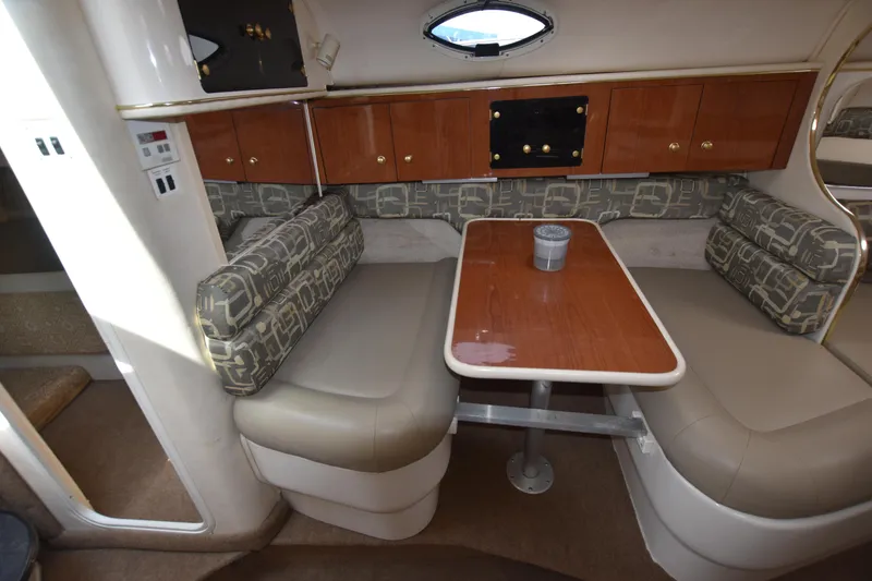 Slide: The Image of Interior of 2000 Monterey 302 Cruiser with dining area and cushioned seating. - 13