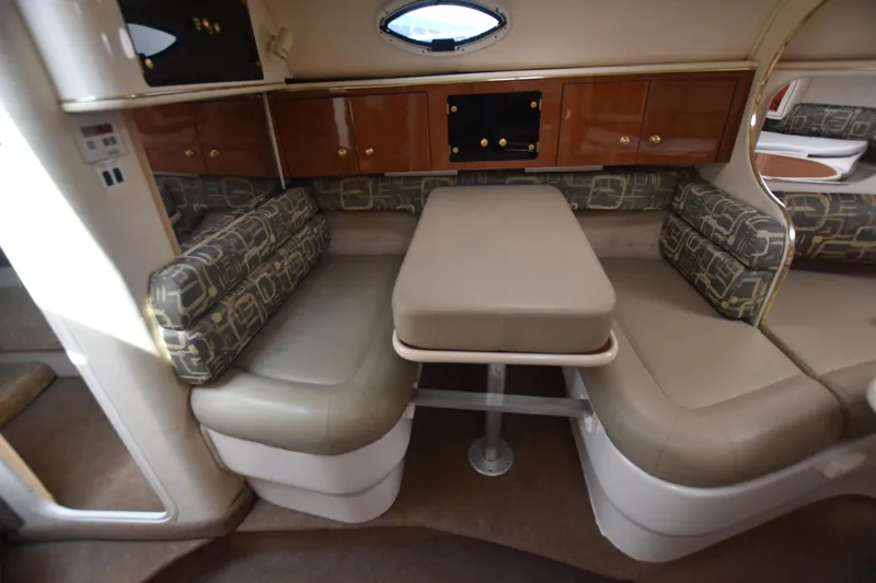 Slide: The Image of Interior of 2000 Monterey 302 Cruiser with dining area and cushioned seating. - 14