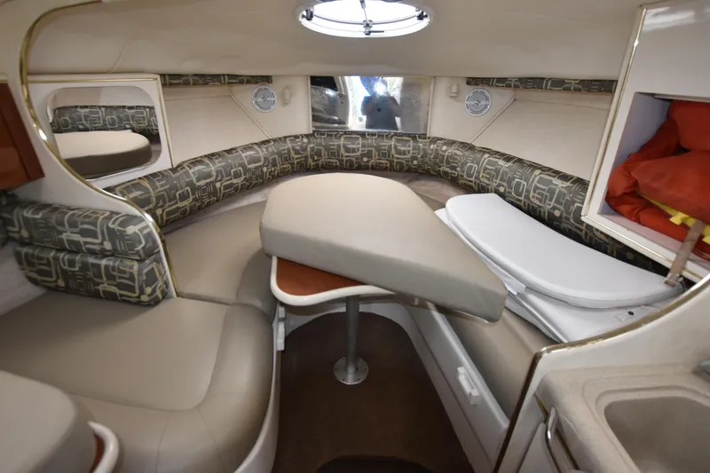 Slide: The Image of Interior of 2000 Monterey 302 Cruiser with cushioned seating and table. - 16
