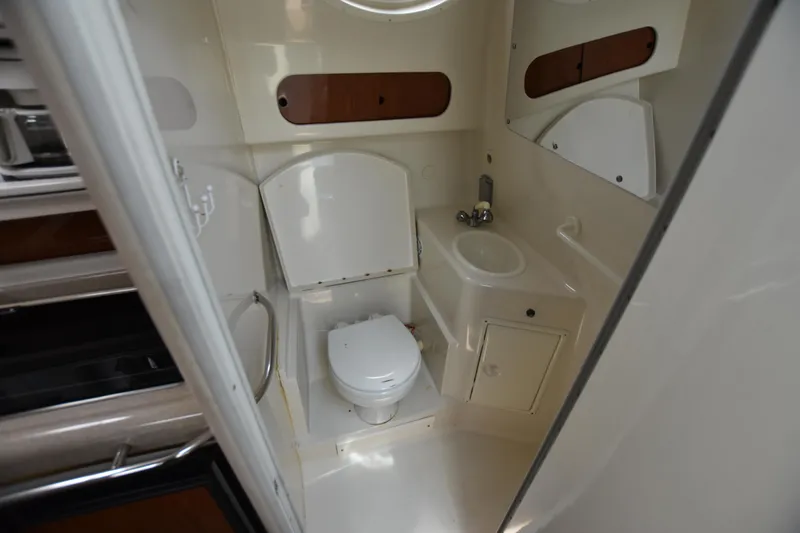 Slide: The Image of Compact bathroom in 2000 Monterey 302 Cruiser boat with toilet and sink. - 18