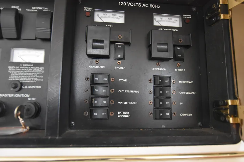 Slide: The Image of Electrical control panel of a 2000 Monterey 302 Cruiser boat, featuring switches and circuit breakers. - 23
