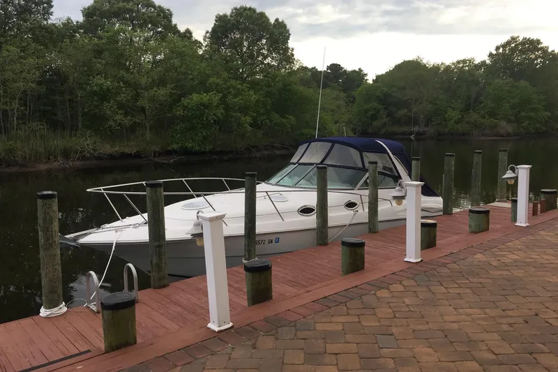 Slide: The Image of 2000 Monterey 302 Cruiser docked by a scenic riverside with lush greenery. - 29