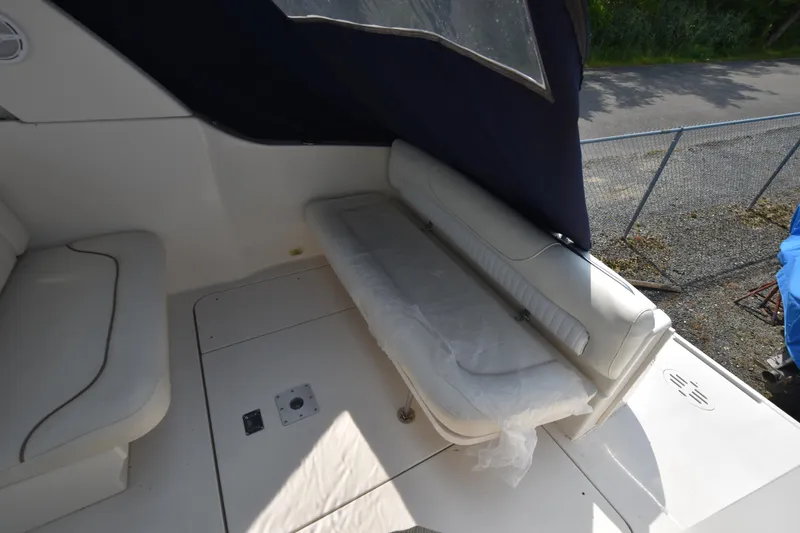 Slide: The Image of 2000 Monterey 302 Cruiser interior with white seating and covered deck area. - 6