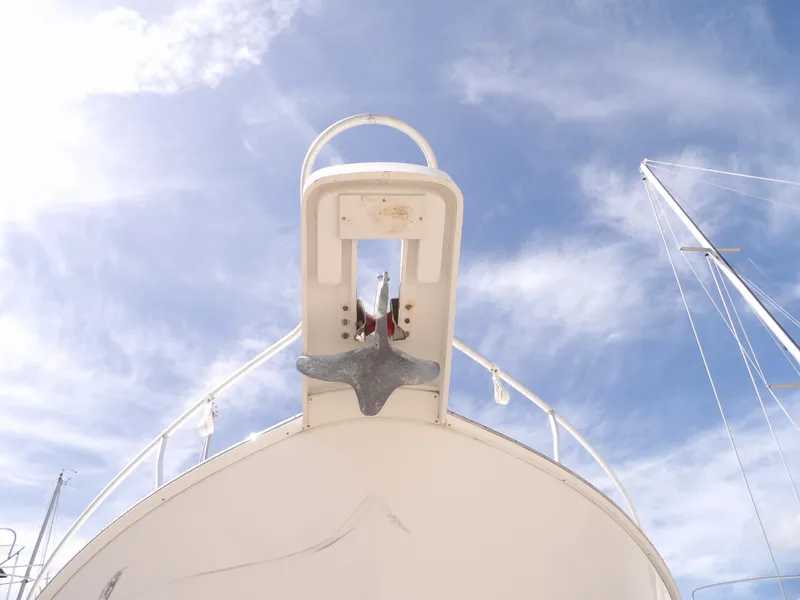 Slide: The Image of 1999 Mainship 350 Trawler bow with anchor against blue sky. - 12