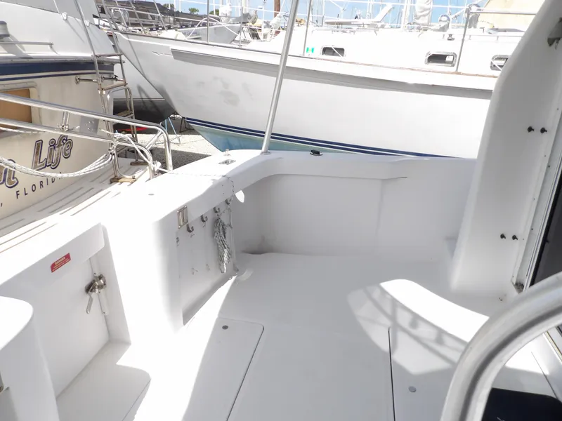 Slide: The Image of 1999 Mainship 350 Trawler deck area with clean, white surfaces and railing. - 14