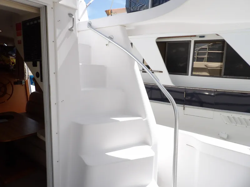 Slide: The Image of 1999 Mainship 350 Trawler interior with white staircase and railing. - 15