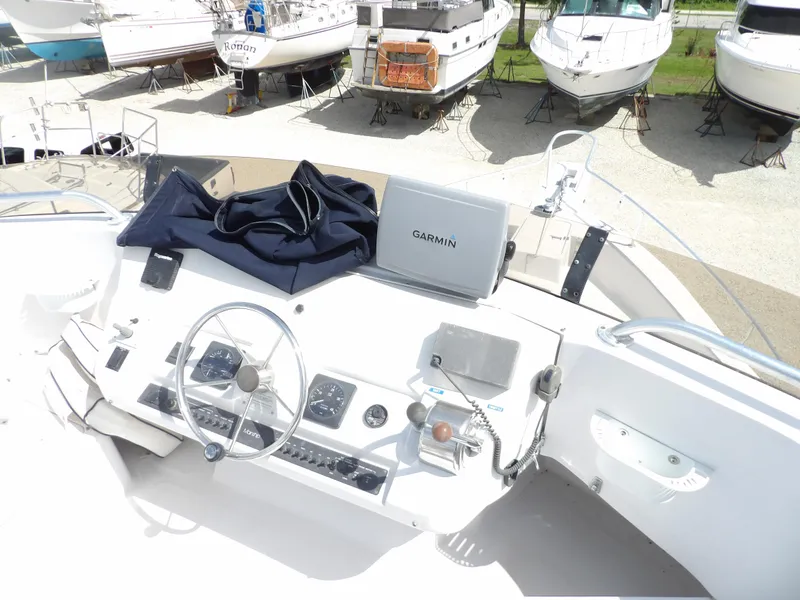 Slide: The Image of Mainship 350 Trawler 1999 helm with Garmin navigation, docked among other boats. - 17