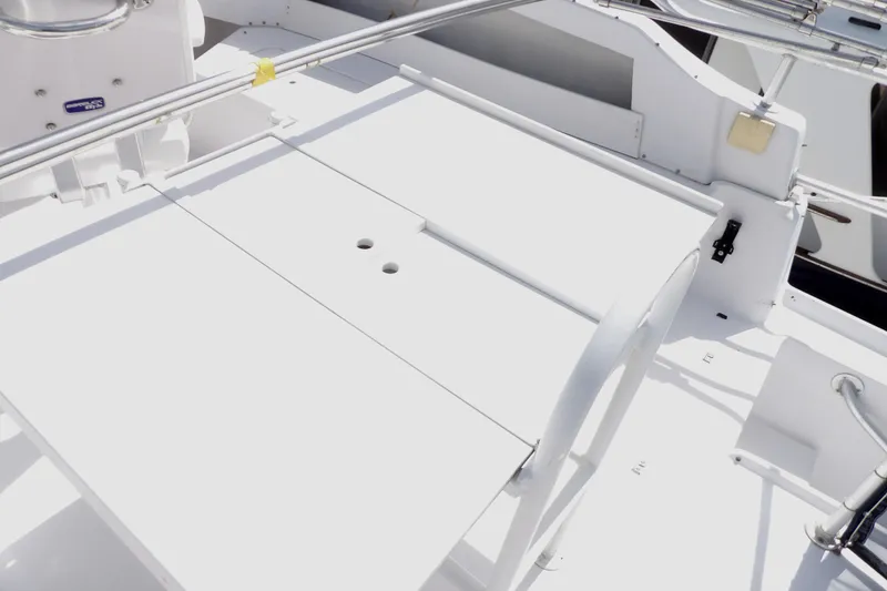 Slide: The Image of 1999 Mainship 350 Trawler deck with white finish and railing. - 26