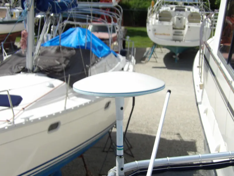 Slide: The Image of 1999 Mainship 350 Trawler in marina, surrounded by other boats. - 30