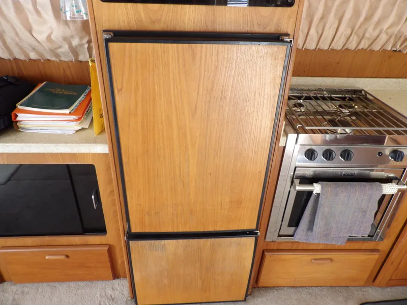 Slide: The Image of Wood-paneled kitchen area in 1999 Mainship 350 Trawler with stove and fridge. - 37