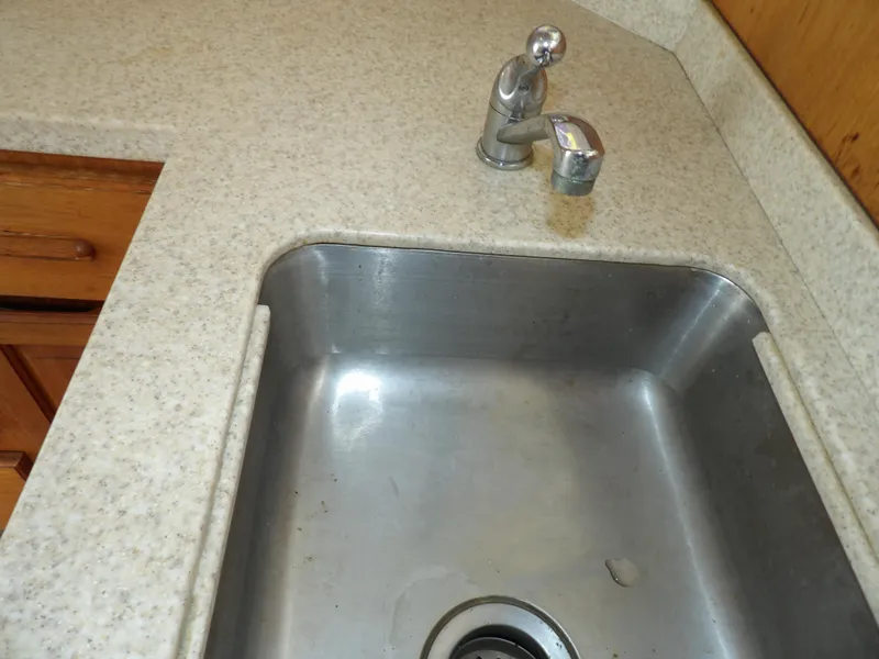 Slide: The Image of Stainless steel sink and faucet in 1999 Mainship 350 Trawler kitchen. - 42